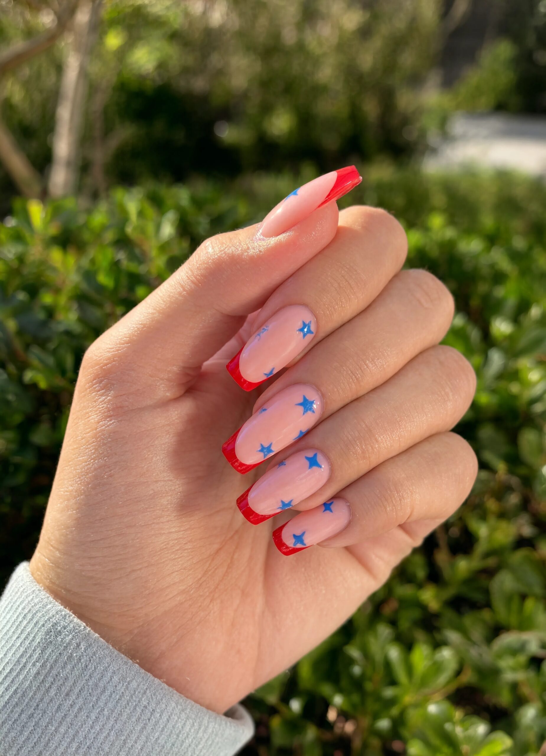Red French tips with blue stars - July Nail Designs